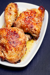 fried chicken with sauce and sesame on white dish