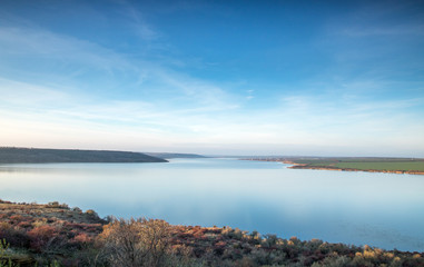 blue sky and clouds, blue lake stil water, panoramic view from high