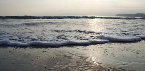 waves on beach at sunset
