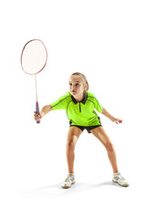 Fototapeta na wymiar The one caucasian young teenager girl playing badminton at studio. The female teen player isolated on white background in motion