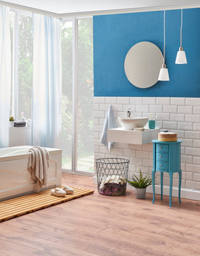 Modern bath room and tub detail with wooden wet floor. Decorative bath room design towel frame and green plant. Garden view style.