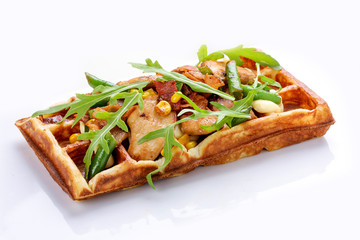 Belgian waffle on a white background. Stuffed with chicken, asparagus and arugula