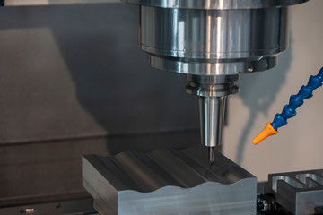 The CNC milling machine cutting the injection mold part by solid ball end mill tool. Mold manufacturing process.