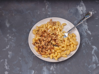 Breakfast of pasta with minced chicken on a white plate