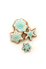 Christmas decoration with cookies in the shape of snowflakes and stars on a white background. Top view.