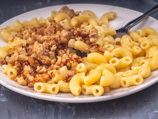 Breakfast of pasta with minced chicken on a white plate