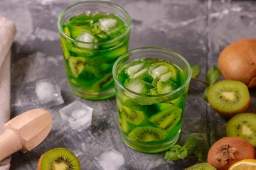 Cocktail with kiwi and mint in a glass on a wooden background. Selective focus. Homemade lemonade with kiwi