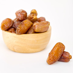 Bowl of dried dates on white