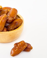 Bowl of dried dates on white