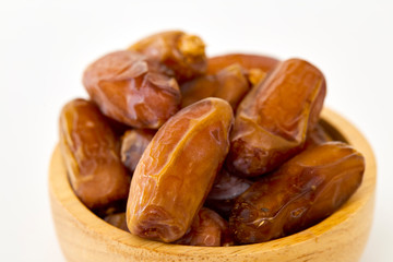 Bowl of dried dates on white