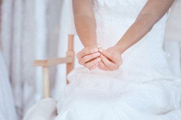 Fototapeta na wymiar Close up of bride hand holding wedding diamond ring