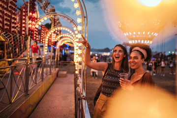 Cropped shot of two young female friends at a amusement park