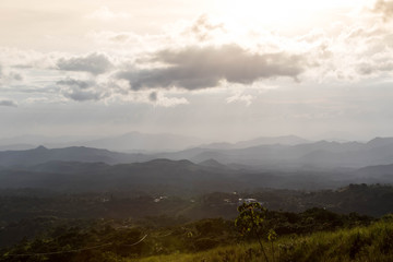 Naklejka premium Sunset at a moountain range in the central part of Panama looking towards a small mountain village