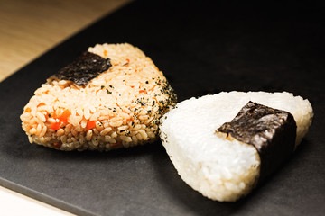 Two triangle sushi pieces with nori