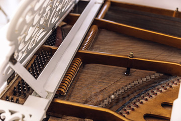 Close-up of a piano from the inside. Instrument with horizontally stretched metal strings.