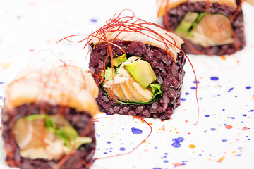 Sushi roll with rice and fresh raw salmon