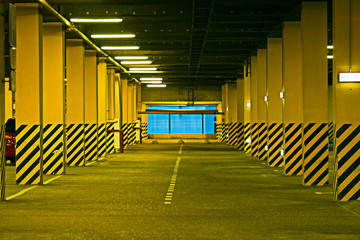 Interior of empty underground parking garage at night