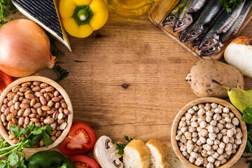 Healthy eating. Mediterranean diet. Fruit,vegetables, grain, nuts olive oil and fish on wooden table. Top view. Copyspace