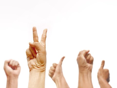 Man hands group in victory, clenched fist and thumbs up signs gesture are raising up to the air on isolated white background in teamwork concept, focus on foreground