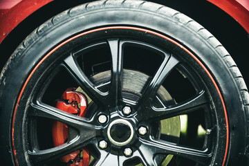 Completed in a high quality gloss. Black rim of luxury car wheel. Car wheel detail. Alloy wheel....