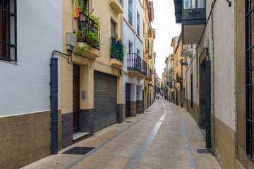 Fototapeta na wymiar PLASENCIA, CACERES, SPAIN - NOVEMBER 18, 2018: Narrow street of the historic center of the medieval city