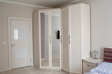 White wardrobe in a bedroom interior. Scandinavian style