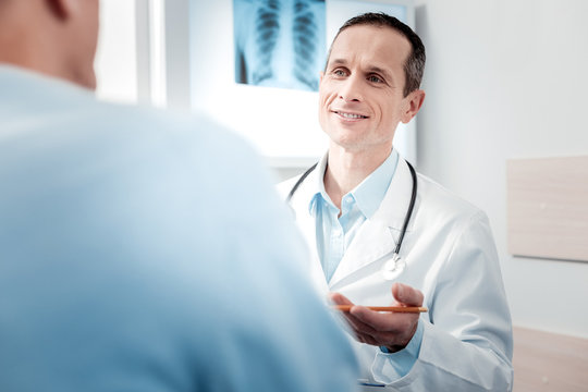 Positive delighted doctor asking questions