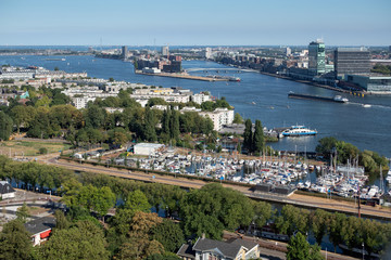 View Dutch harbor Amsterdam with marina, ferry and apartment buildings