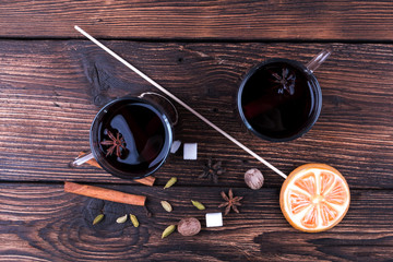 Glasses of mulled wine, Cooking with spices, cardamom, cinnamon on kitchen table background top view