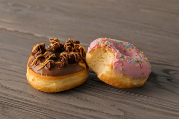 Chocolate and bitten pink doughnuts in the morning light.
