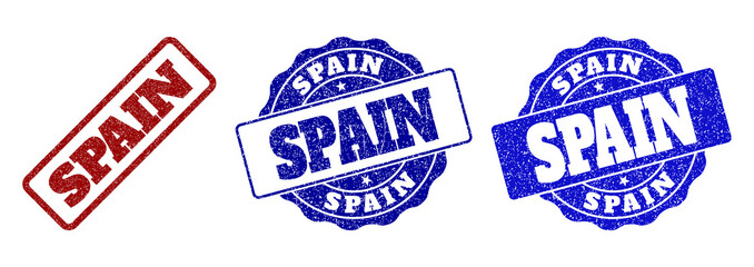 SPAIN grunge stamp seals in red and blue colors. Vector SPAIN watermarks with grunge surface. Graphic elements are rounded rectangles, rosettes, circles and text titles.