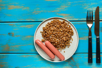buckwheat, Bowl of tasty porridge on wooden table, top view. copy space