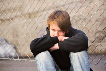 A Sorrowful Kid on the City Street