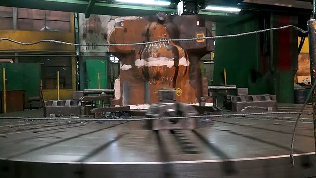 huge lathe closeup, large spindle lathe is rotating at an industrial plant. Shooting is made at a plant producing power steam turbines,Turning lathe in action,Industrial CNC drill machine