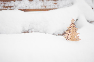Small Christmas tree covered with snow and copy space