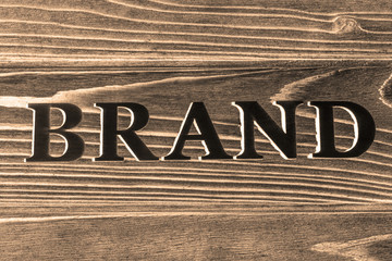 the word brand on a wooden background.