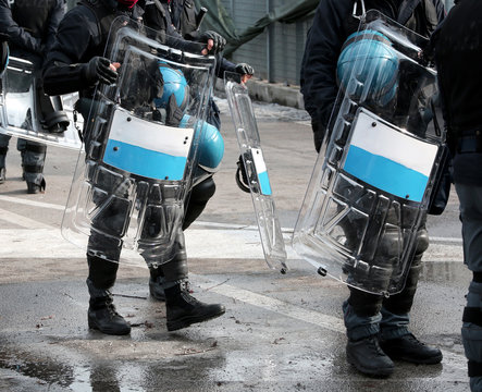 policemen with shields and riot gear