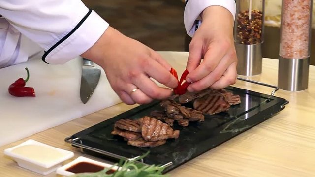 Cooking meat with spice, Chef preparing and spicing meat, Professional chef cooking, working and preparing meat restaurant kitchen, man at work as cook