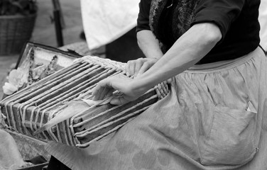 woman working with her hands creates an handmade bag