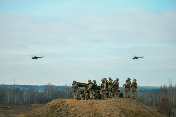 military army helicopters flying above military field
