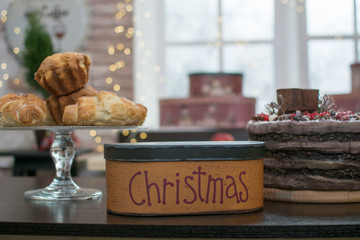  Gifts under the Christmas tree. New Year and Christmas gifts. Beautiful gifts for Christmas and New Year. Gift box on the table with croissants and cake