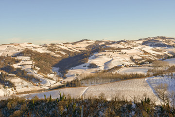Snow covered landscape with vineyard hills in winter, Langhe, Piedmont, Italy