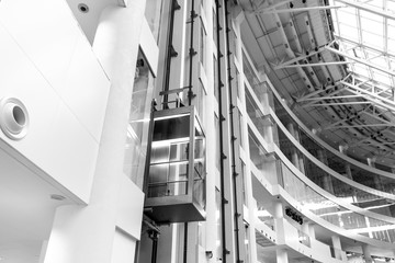 Glass Elevator in office building in black and white color, elevators to success.