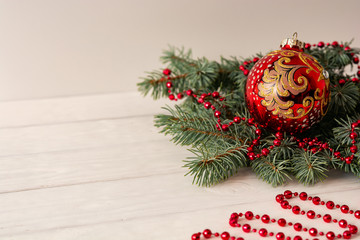 Christmas toy with a branch of spruce on a white background