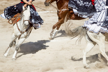 Group of mexican escaramuza performs a stun on horse in a rodeo