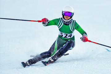 Fototapeta na wymiar An alpine ski racer rounding a gate during a race.