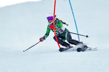 Foto op Canvas An alpine skier racing on the slalom course. © Daniel Teetor