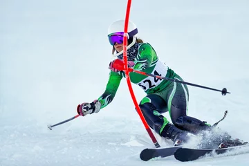 Foto op Canvas An alpine skier punching a gate during a slalom race. © Daniel Teetor