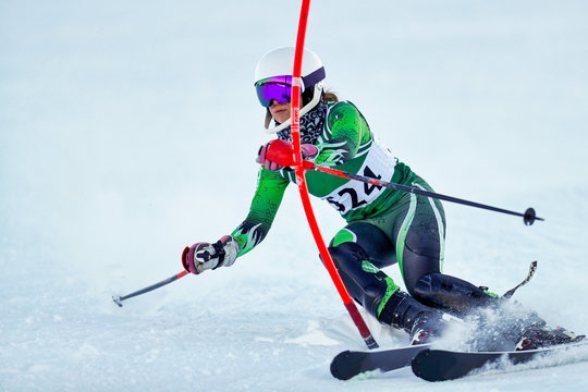 An alpine skier punching a gate during a slalom race.