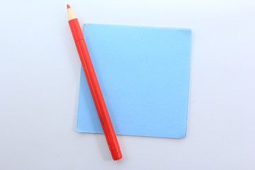 blue paper with red pen on white background